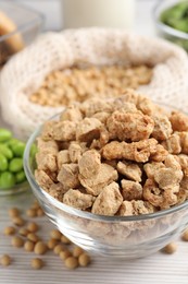 Dehydrated soy meat and other organic products on white wooden table, closeup