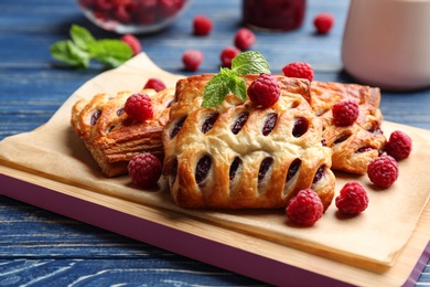 Fresh delicious puff pastry with sweet berries served on blue wooden table