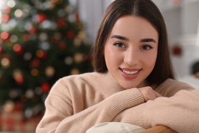 Photo of Christmas mood. Portrait of smiling woman indoors