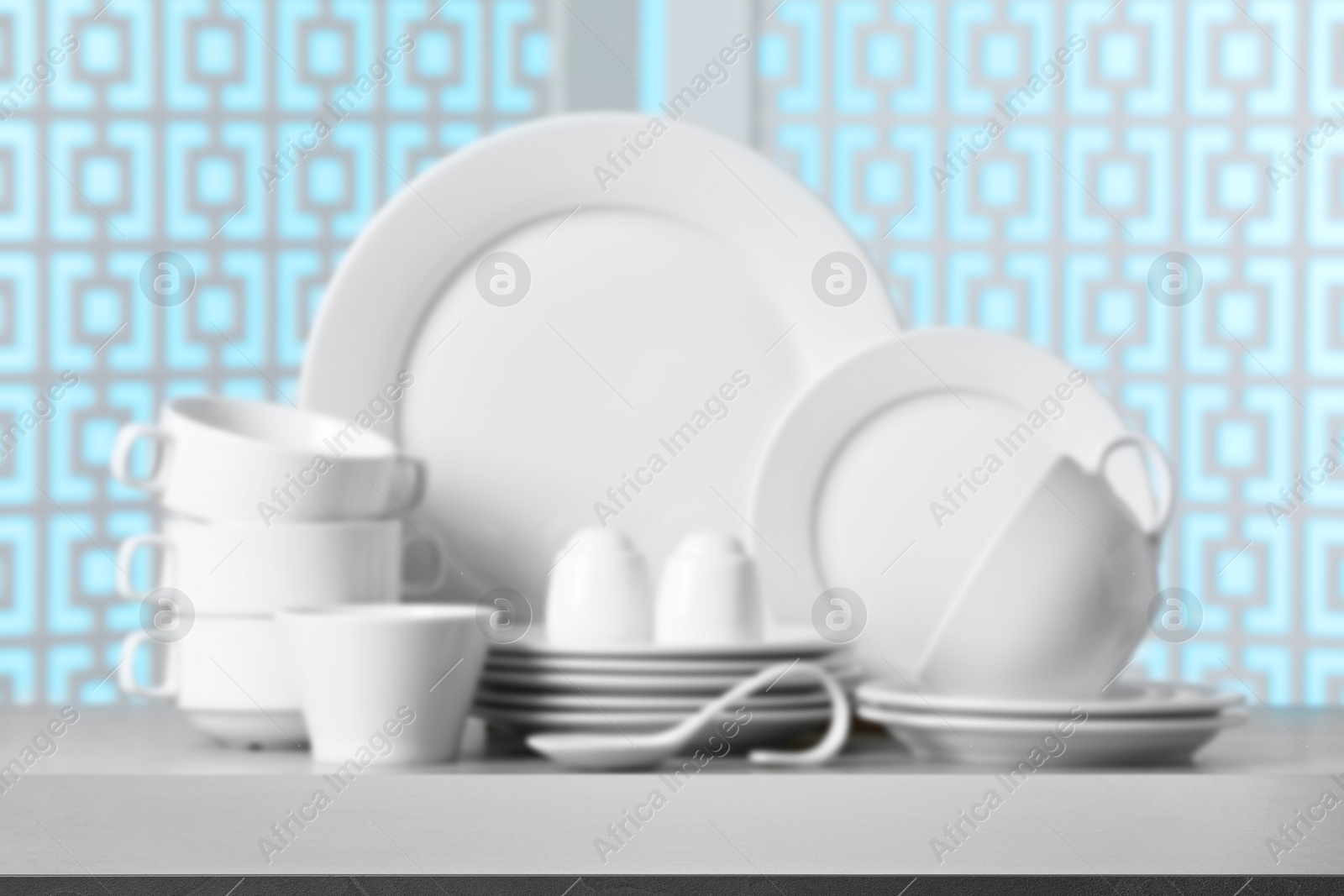 Image of Set of clean dishware, focus on empty stone table