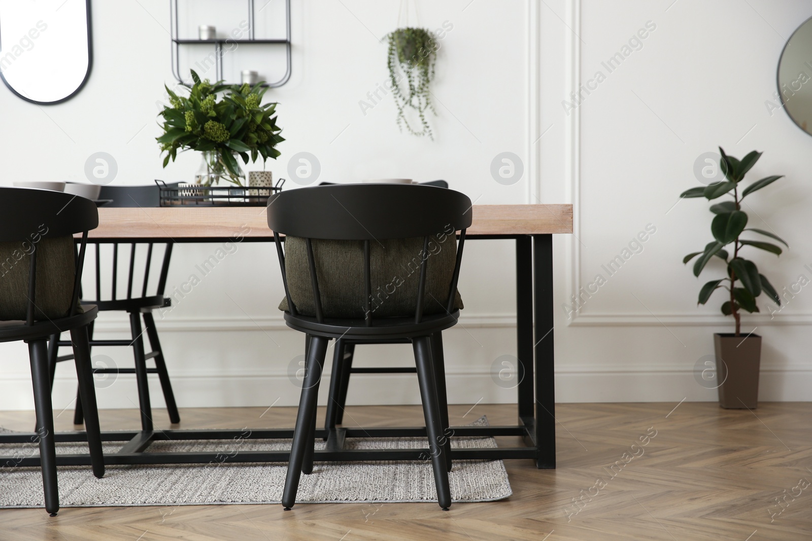 Photo of Stylish wooden dining table and chairs in room. Interior design