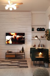 Plasma TV on white wooden wall in living room beautifully decorated for Christmas