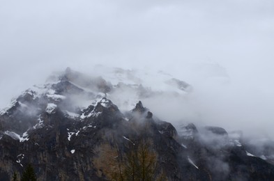 Photo of Picturesque view of mountain covered with fog