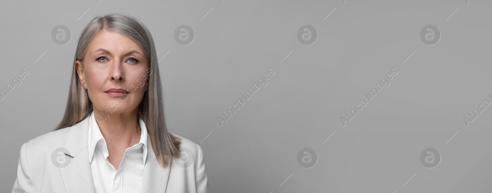 Image of Portrait of beautiful mature woman on light grey background. Banner design with space for text