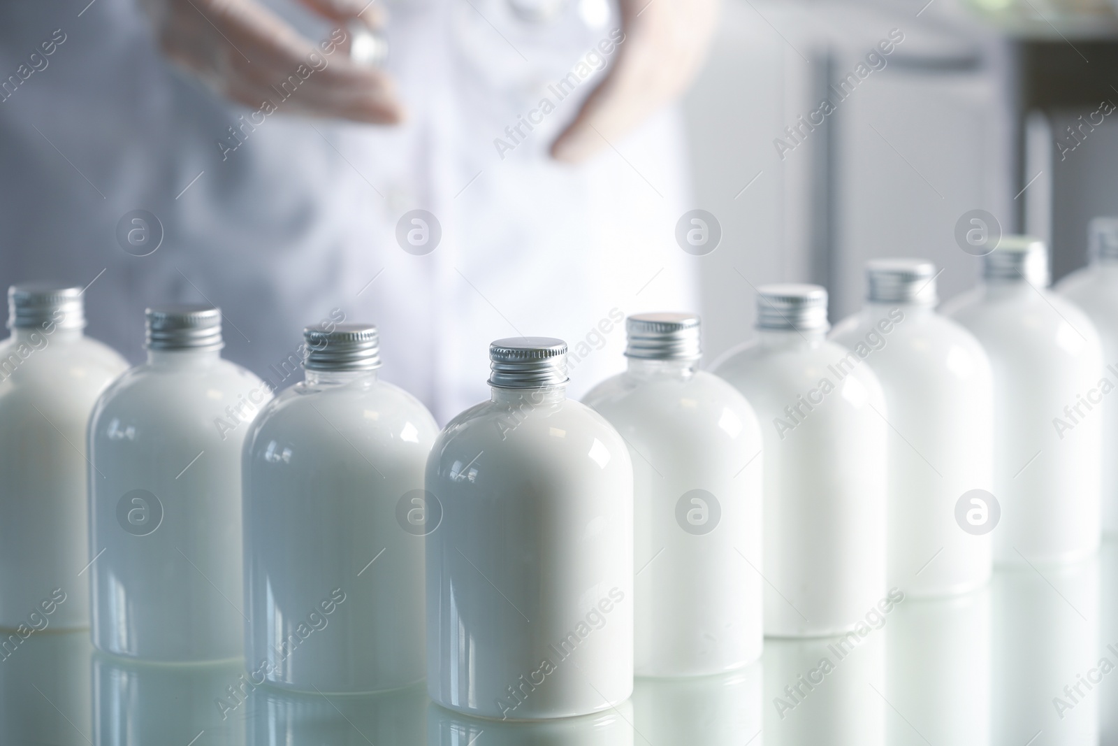 Photo of Many bottles with cosmetic product in laboratory