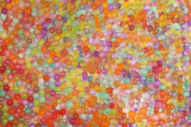 Photo of Closeup view of different color vase fillers as background. Water beads