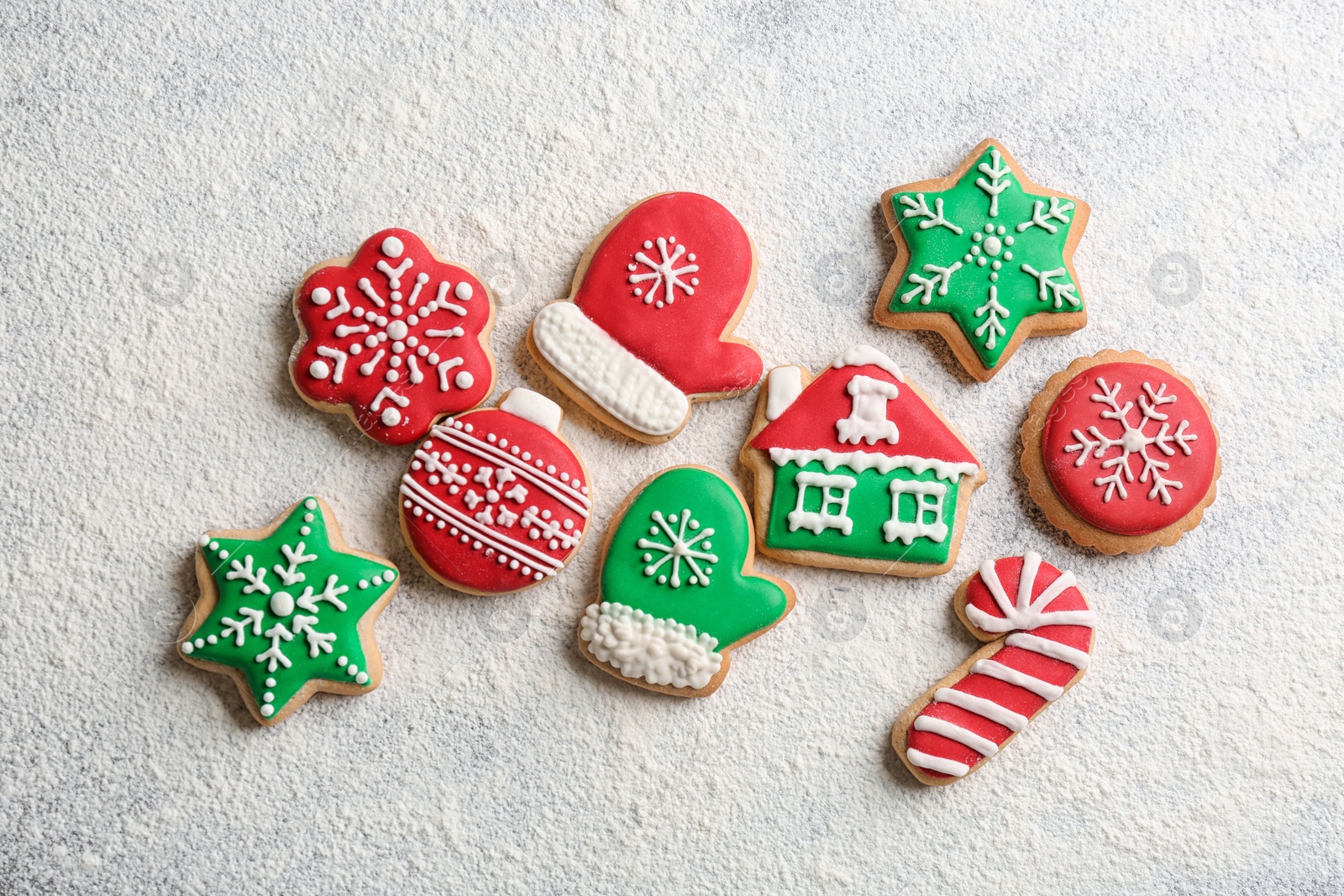 Photo of Different tasty homemade Christmas cookies and flour on table, flat lay