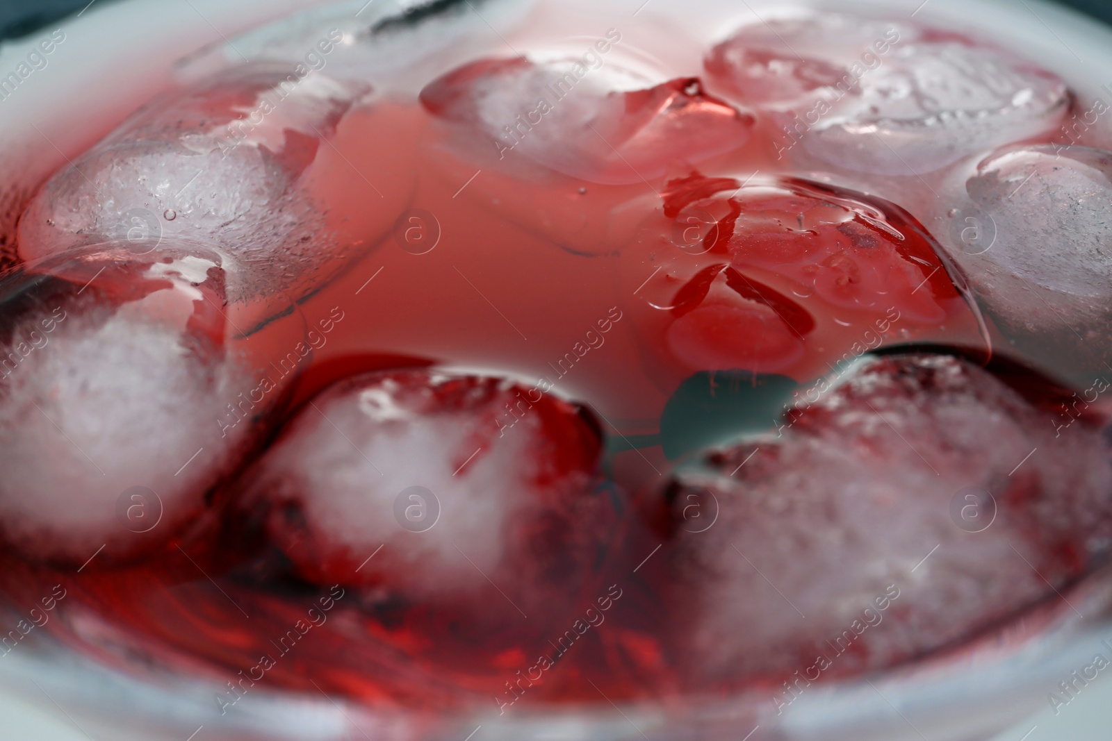 Photo of Martini cocktail with ice cubes in glass, closeup