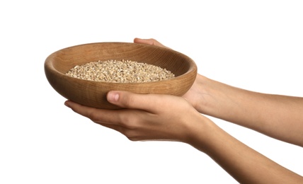 Photo of Poor woman holding bowl with grains on white background, closeup