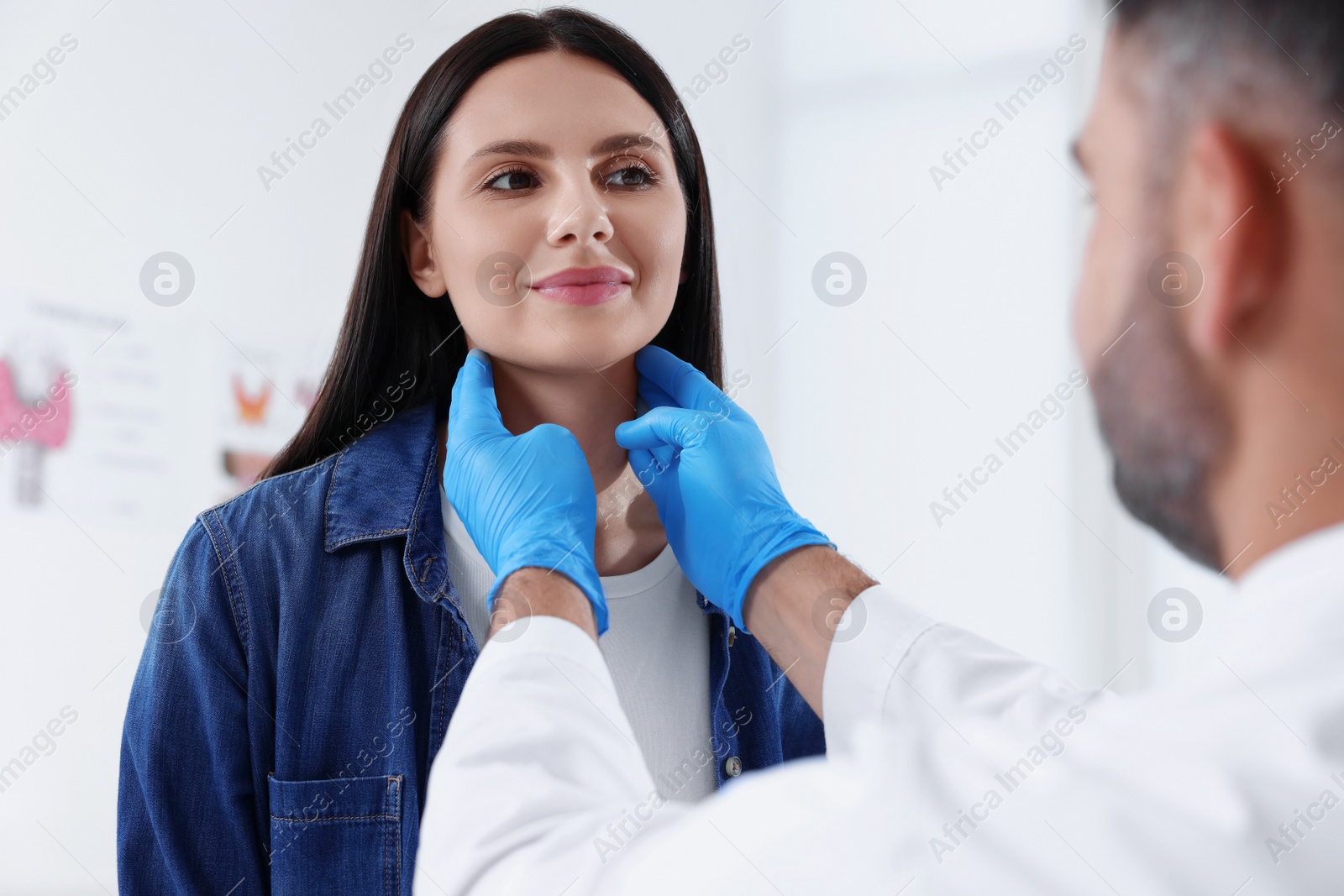 Photo of Endocrinologist examining thyroid gland of patient at hospital, closeup