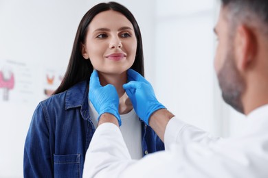 Endocrinologist examining thyroid gland of patient at hospital, closeup