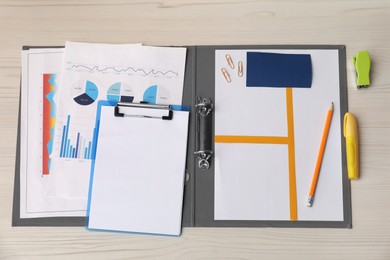 Photo of Business process planning and optimization. Documents with different types of graphs and stationery on wooden table, flat lay