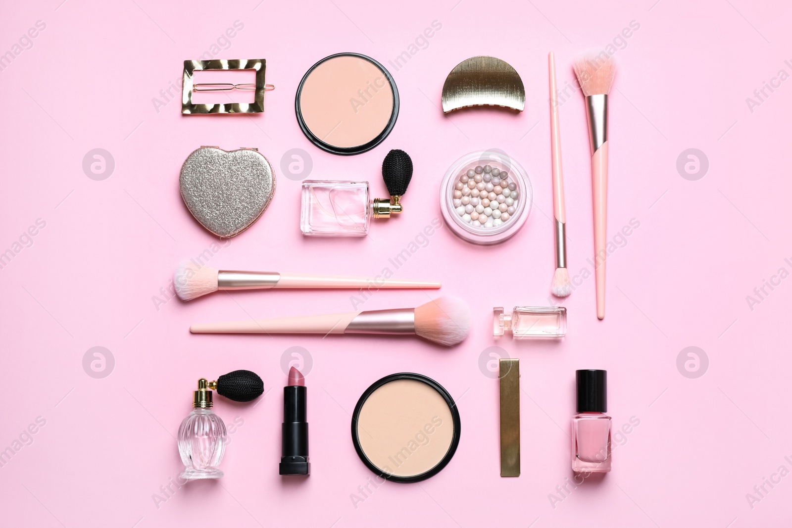 Photo of Makeup brushes and cosmetic products on pink background, flat lay