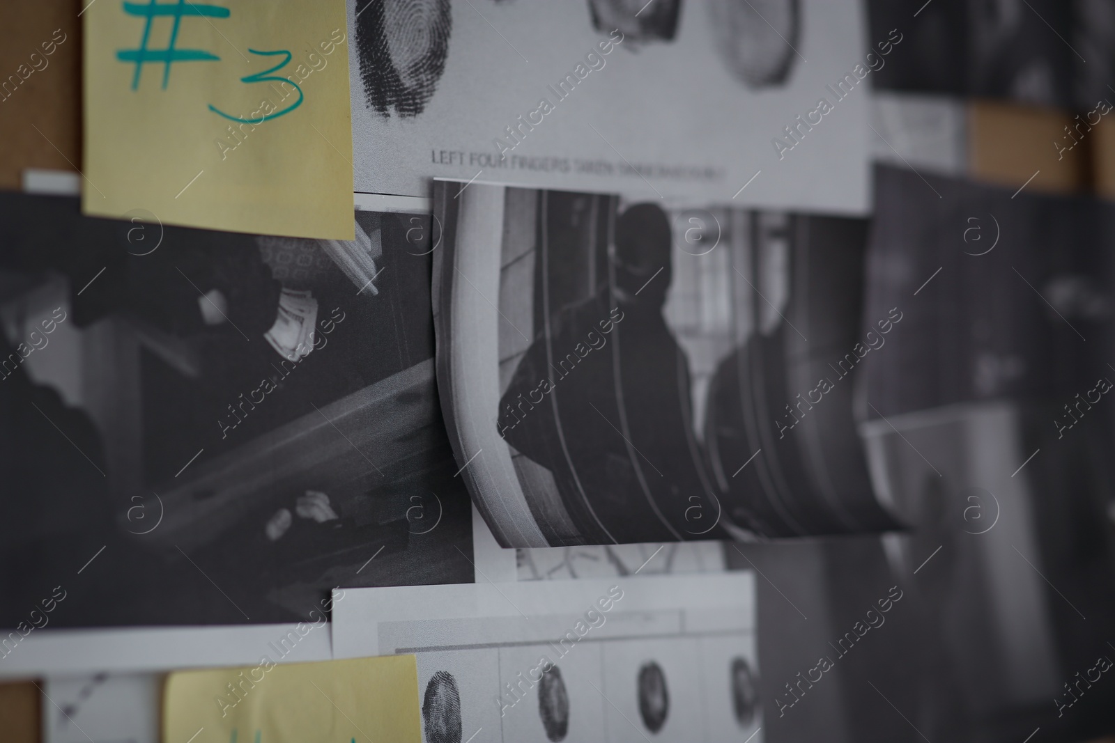 Photo of Detective board with sticker, fingerprints and crime scene photos, closeup