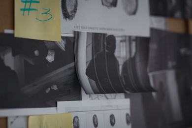 Detective board with sticker, fingerprints and crime scene photos, closeup