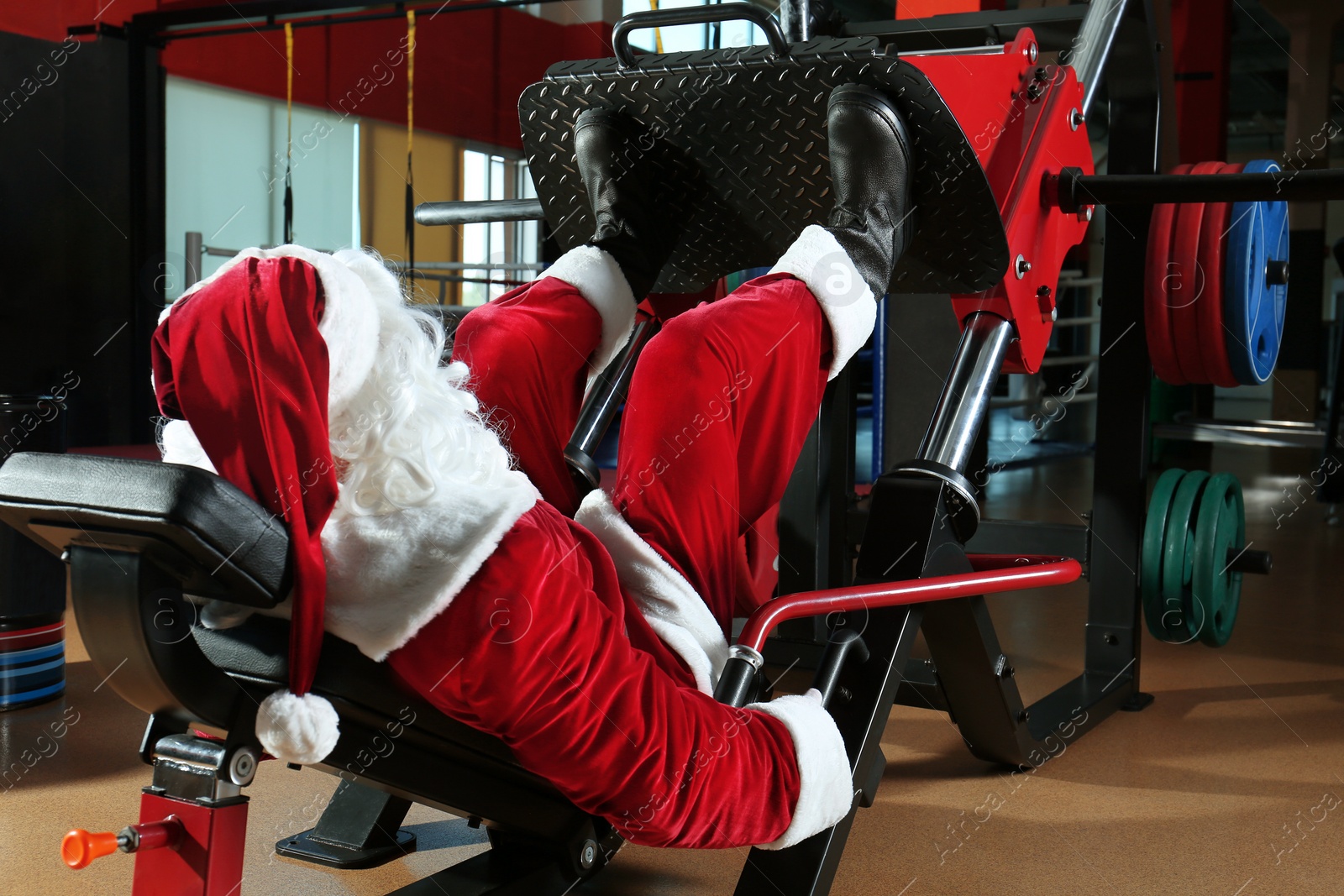 Photo of Authentic Santa Claus training in modern gym