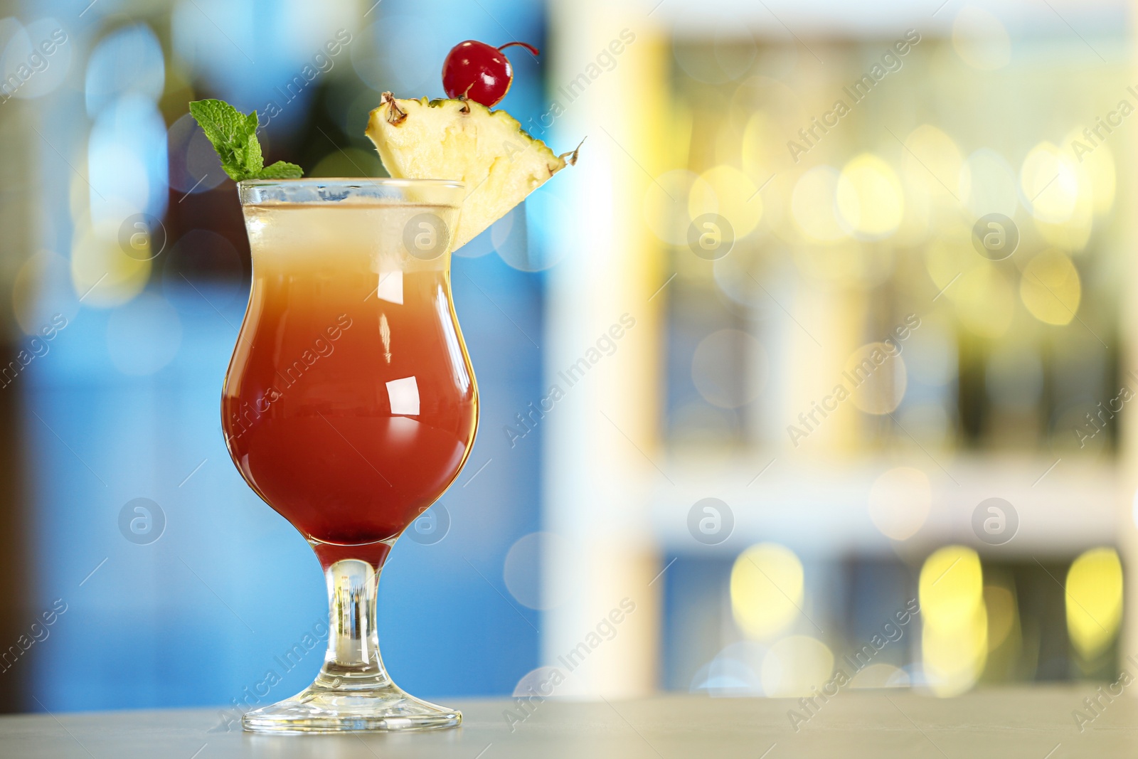 Photo of Fresh alcoholic cocktail with pineapple and mint on bar counter, space for text