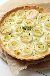 Photo of Tasty leek pie with thyme on white wooden table, closeup