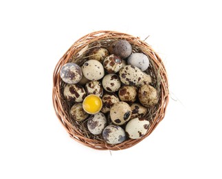 Wicker bowl with whole, cracked quail eggs and straw isolated on white, top view