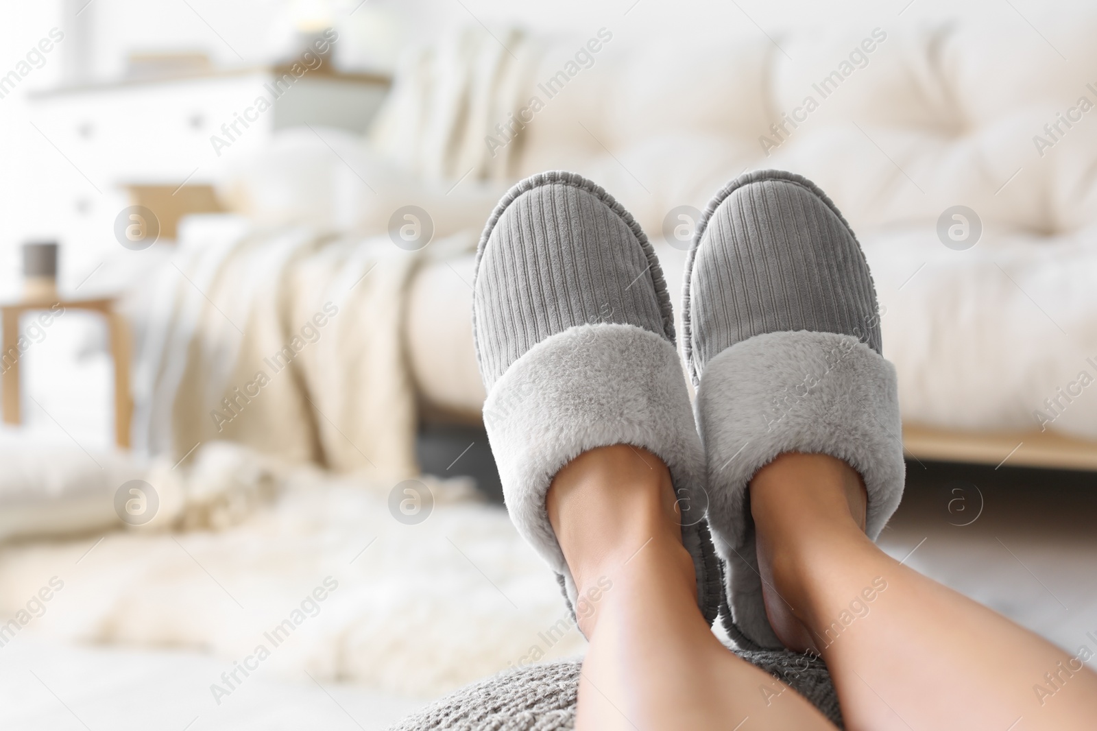 Photo of Woman wearing soft comfortable slippers at home, closeup