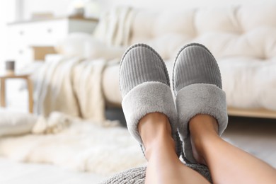 Photo of Woman wearing soft comfortable slippers at home, closeup