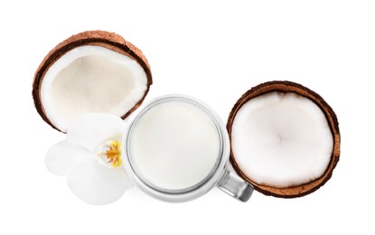Photo of Mason jar of delicious vegan milk, coconut and flower on white background, top view