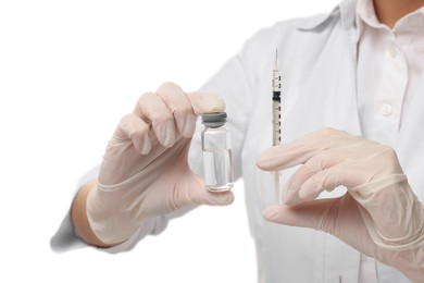 Photo of Doctor holding medical syringe and glass vial on white background, closeup