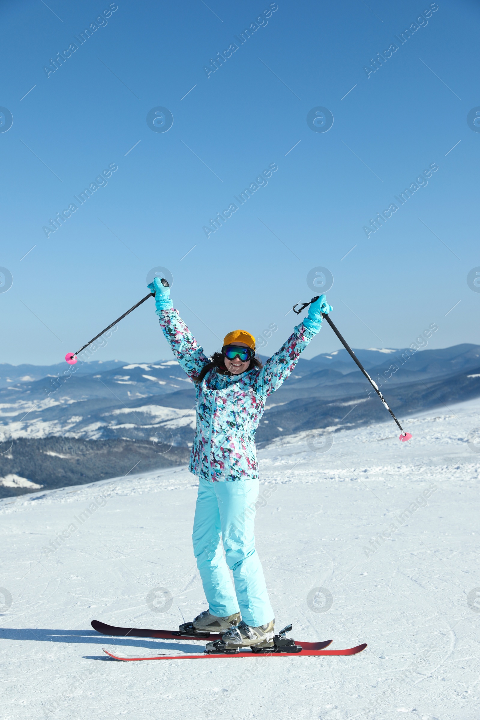 Photo of Female skier on snowy slope in mountains. Winter vacation