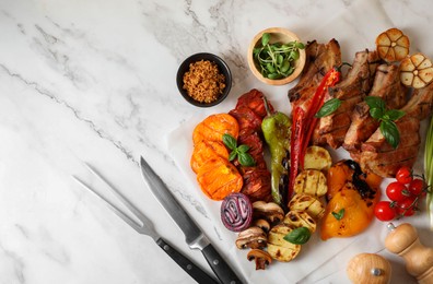 Photo of Delicious grilled meat and vegetables served on white marble table, flat lay