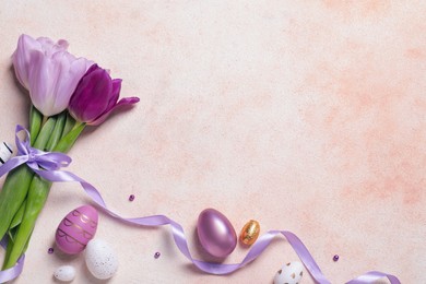Photo of Flat lay composition with festively decorated Easter eggs and beautiful tulips on color textured background. Space for text