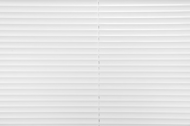 Photo of Window with closed white horizontal blinds as background