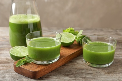 Glassware with delicious detox juice and ingredients on table