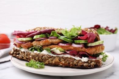 Photo of Delicious sandwich with schnitzel on white table, closeup