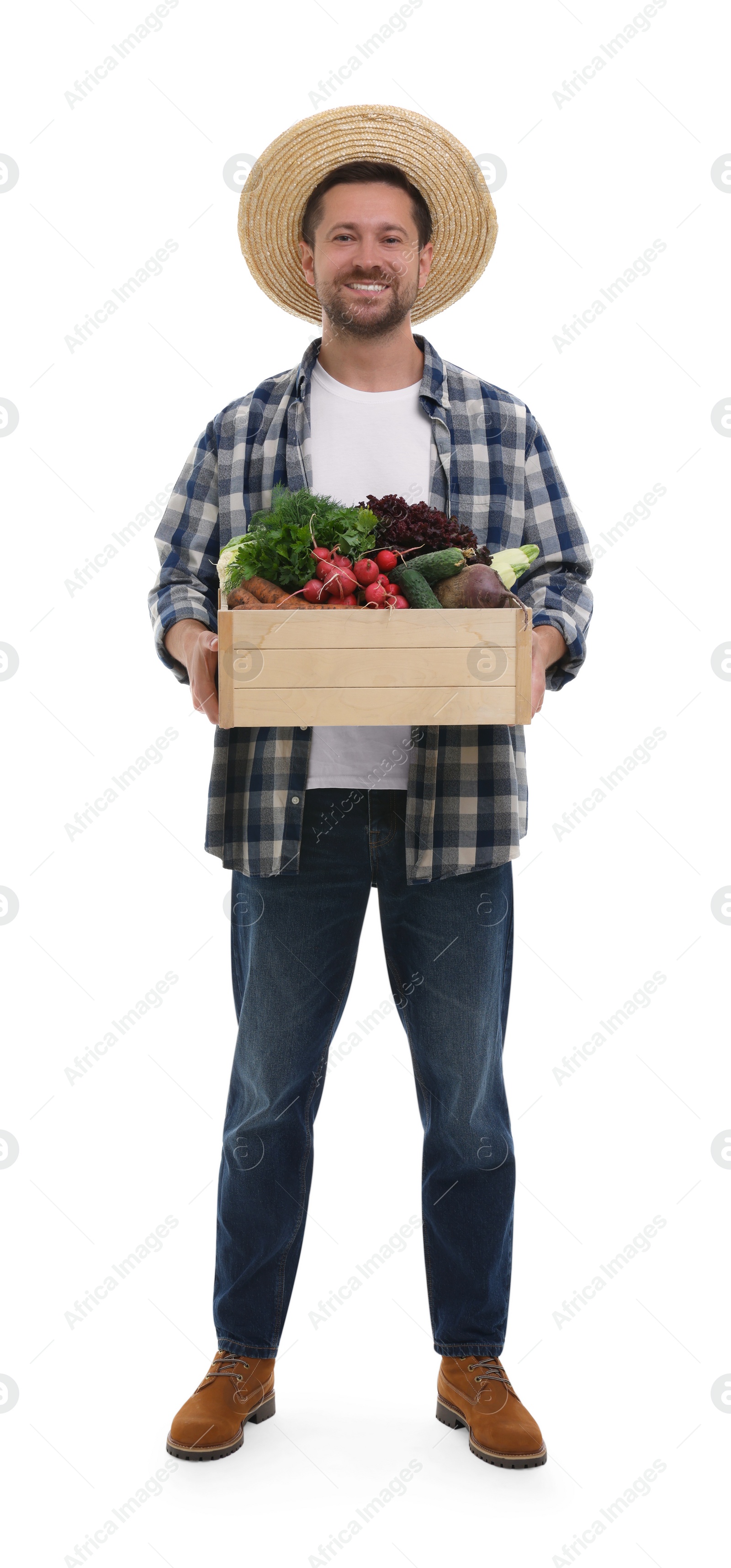 Photo of Harvesting season. Happy farmer holding wooden crate with vegetables on white background