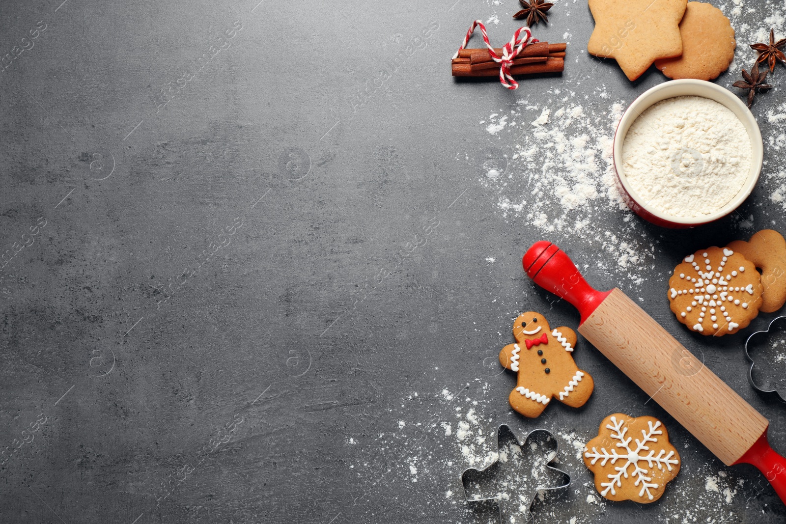 Photo of Flat lay composition with tasty homemade Christmas cookies on dark grey table, space for text