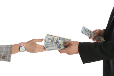 Man giving bribe money to woman on white background, closeup of hands