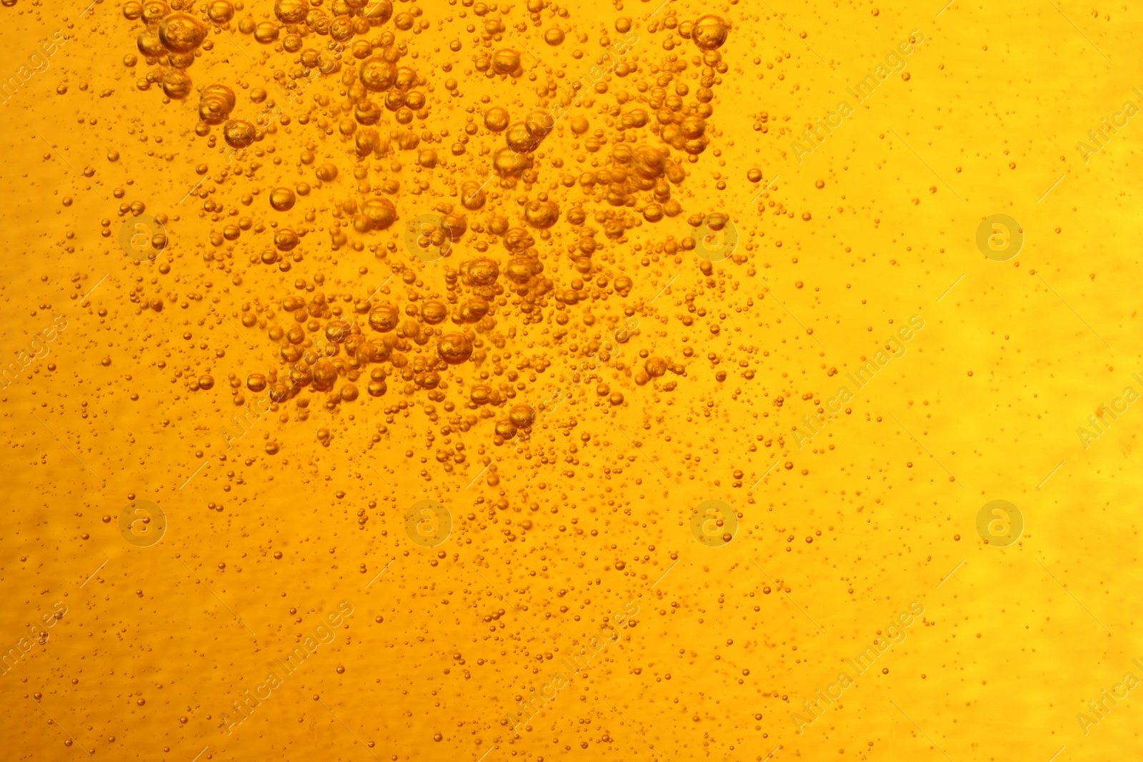 Photo of Tasty beer with bubbles as background, closeup