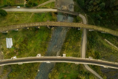 Image of Aerial view of bridges over river on autumn day