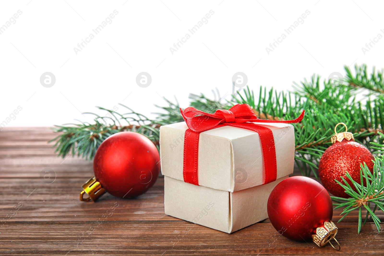 Photo of Beautiful Christmas composition with festive decor and gift box on table against white background