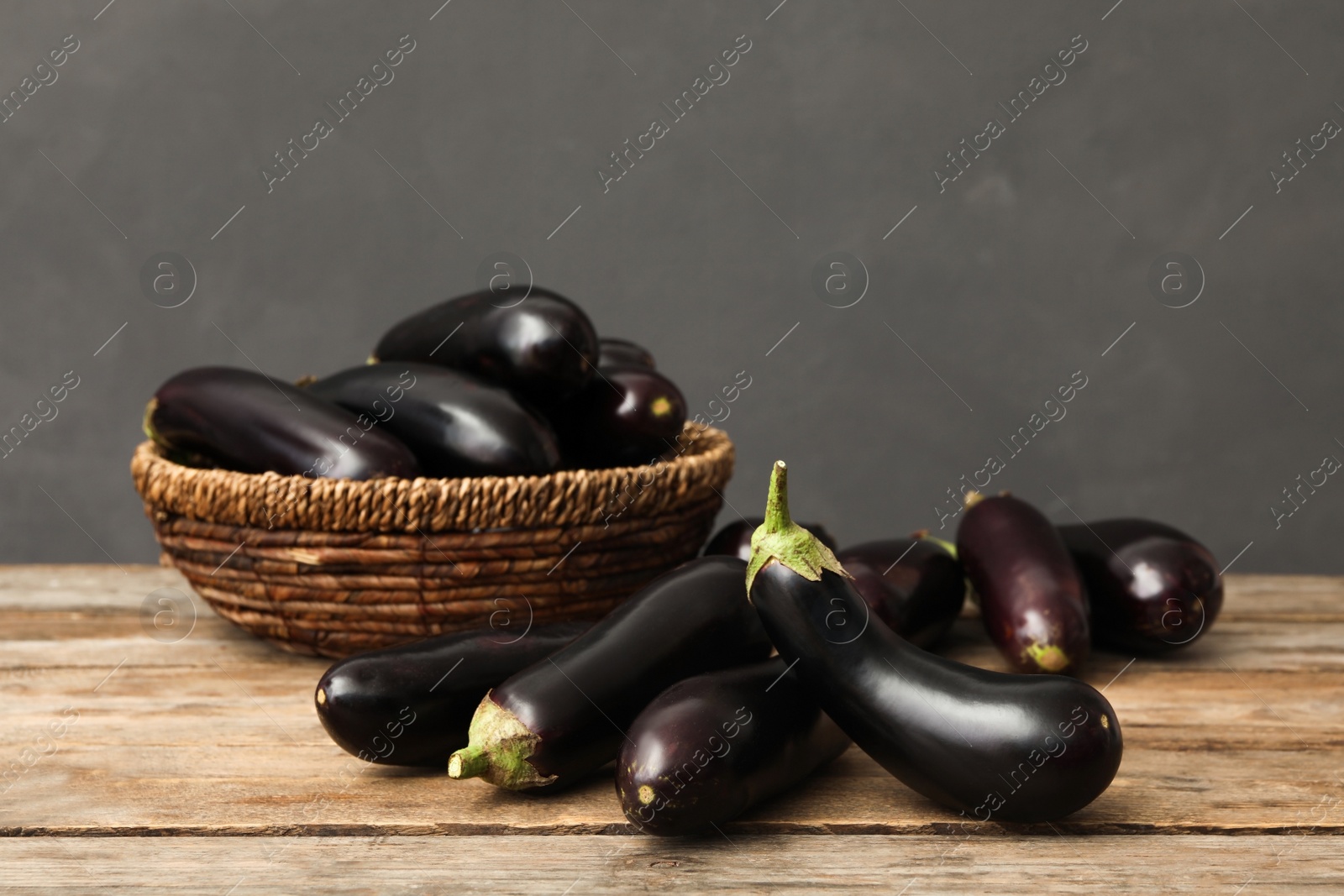 Photo of Many raw ripe eggplants on wooden table