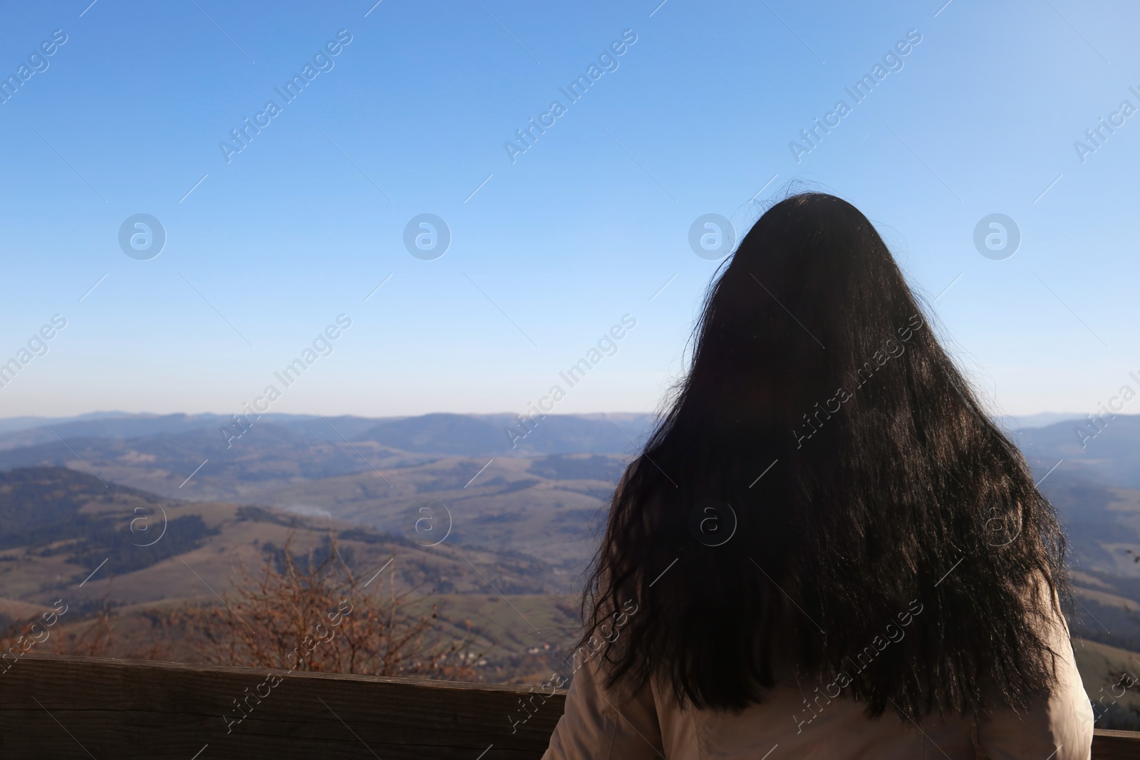 Photo of Woman in warm clothes enjoying mountain landscape