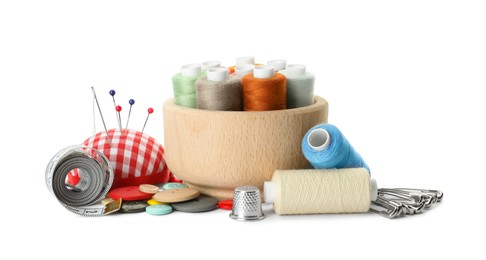 Photo of Spools of threads and sewing tools on white background