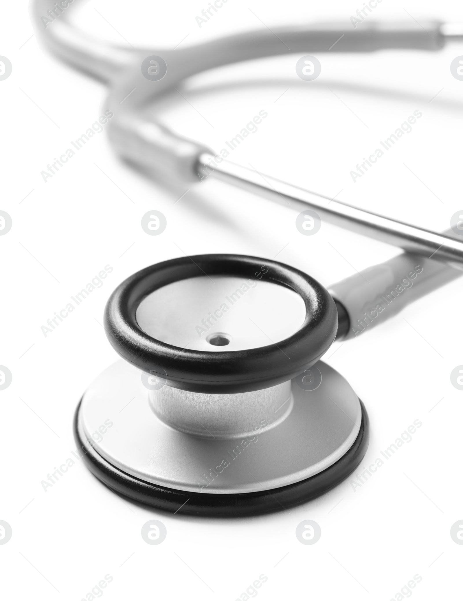 Photo of Modern stethoscope on white background, closeup view