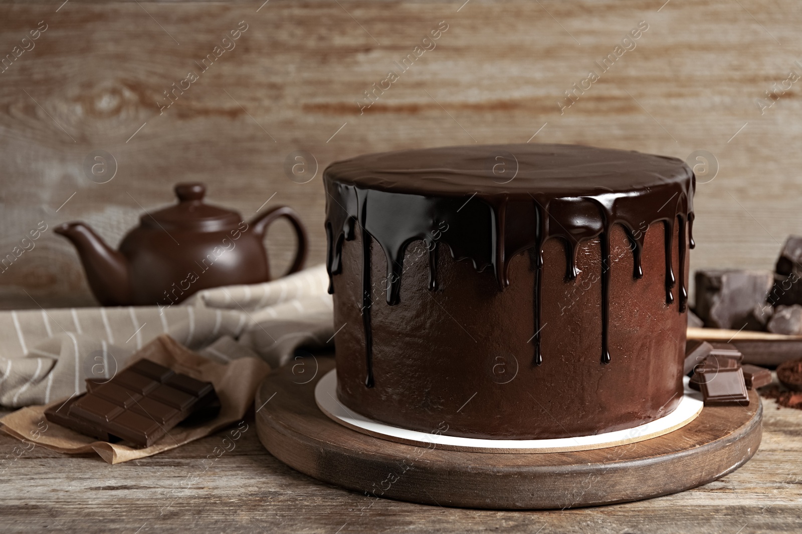 Photo of Freshly made delicious chocolate cake on wooden table