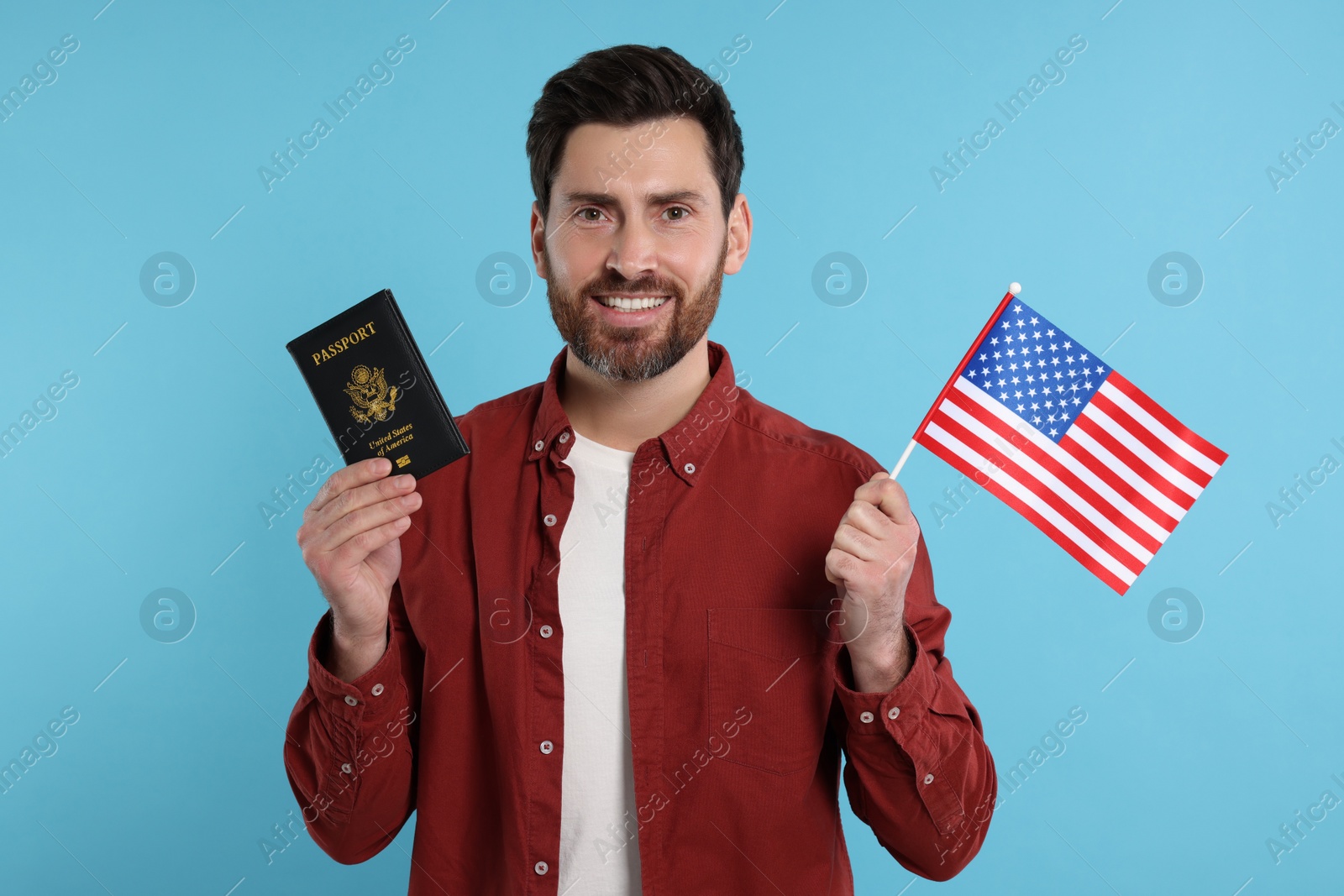 Photo of Immigration. Happy man with passport and American flag on light blue background