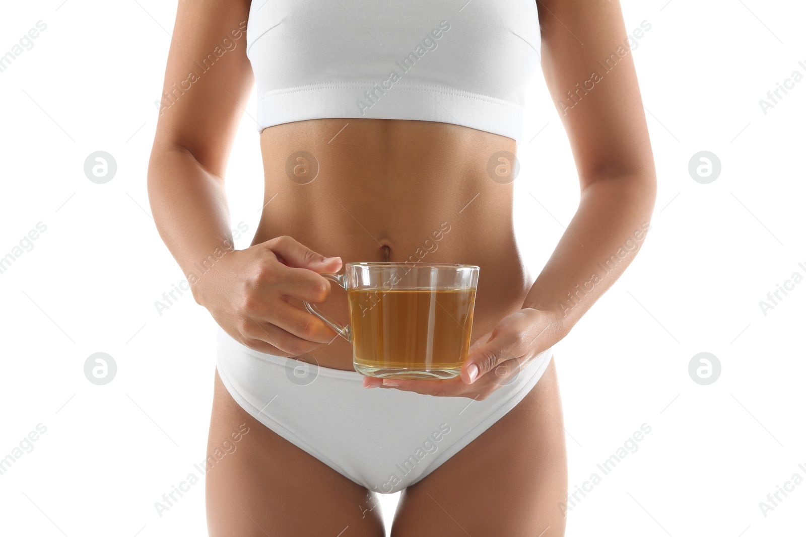 Photo of Young woman holding cup of diet tea on white background, closeup