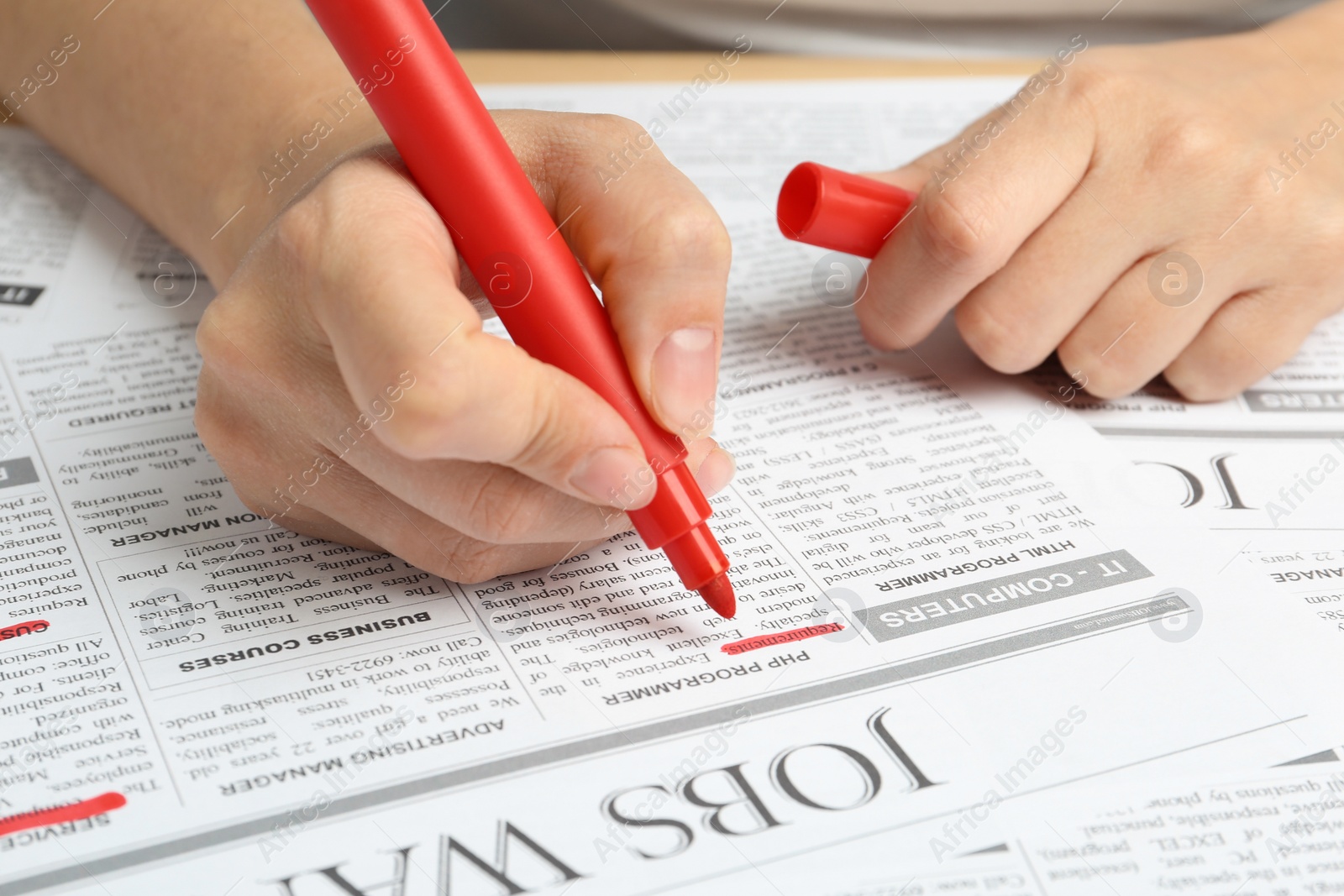 Photo of Woman marking advertisement in newspaper, closeup. Job search concept