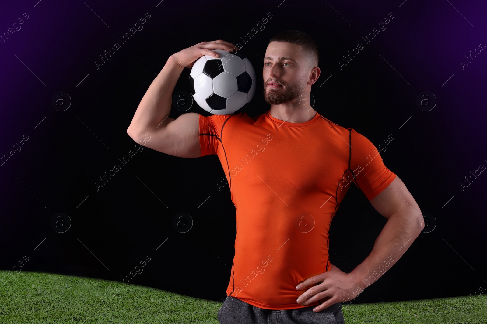 Image of Athletic young man with soccer ball on stadium