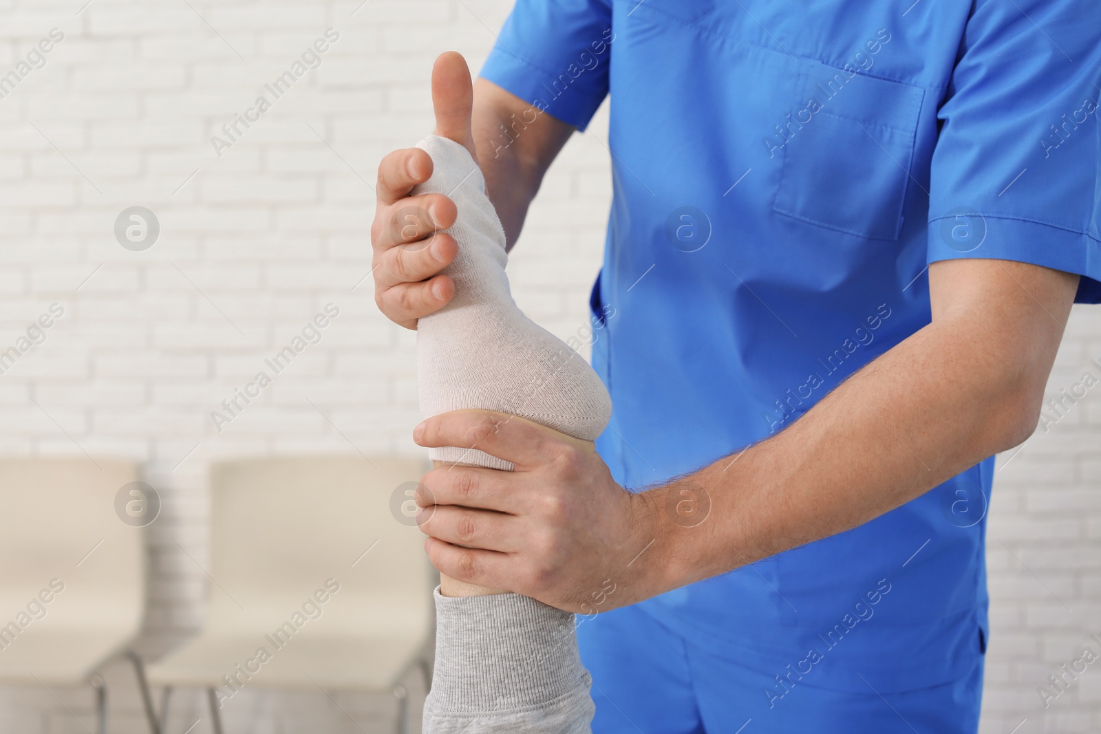 Photo of Physiotherapist working with patient in clinic, closeup. Rehabilitation therapy