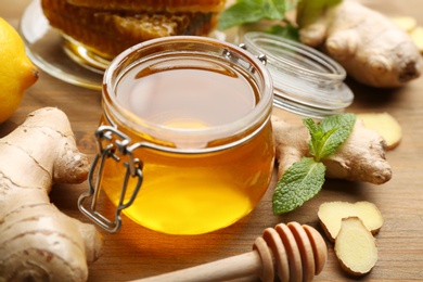 Photo of Honey, ginger, mint and honey on wooden table. Natural cold remedies